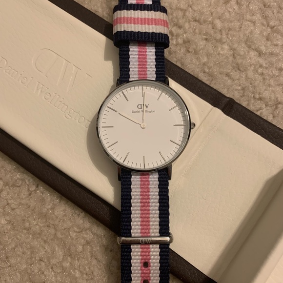 Daniel Wellington women’s pink and blue striped watch.